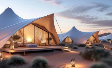 Luxury glamping tents in the Moroccan Sahara at sunset, with cozy lounge areas and elegant desert decor