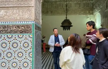 Tourists on a guided sightseeing tour in a historic Moroccan medina