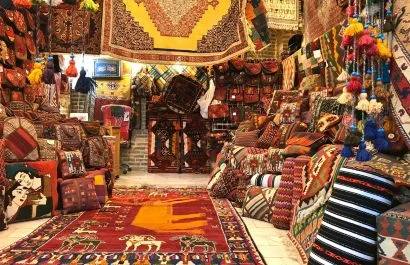 Tradional Moroccan handicrafts and carpets displayed in a vibrant souk